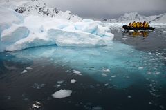11A Zodiac Next To Iceberg With Blue Portion Below Water In Paradise Harbour On Quark Expeditions Antarctica Cruise.jpg